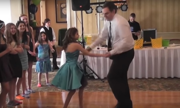 Az édesapa tanácstalanul néz szerteszét, amikor egy ritmusosabb számot kezdenek játszani. Végül bevállalja, és kegyetlen nagyot táncol a lányával